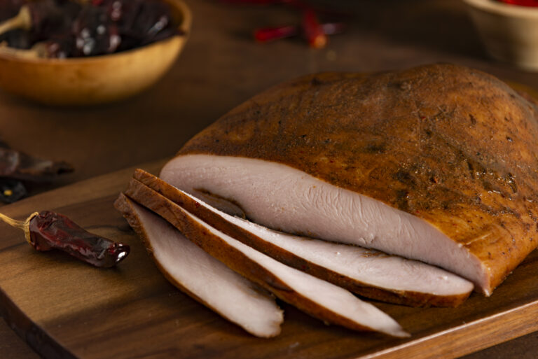 Slices of Farmers & Cooks Fireside Roast Turkey on cutting board