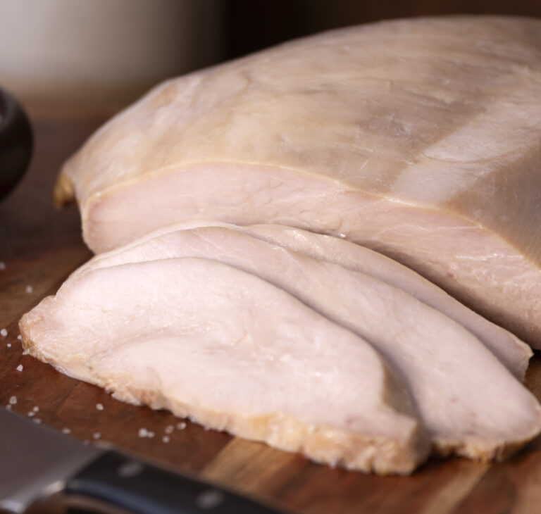 Sliced Farmers & Cooks Simple Roast Turkey on wooden cutting board