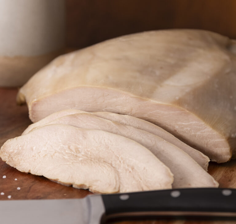 Sliced Simple Roast Turkey on cutting board with a knife